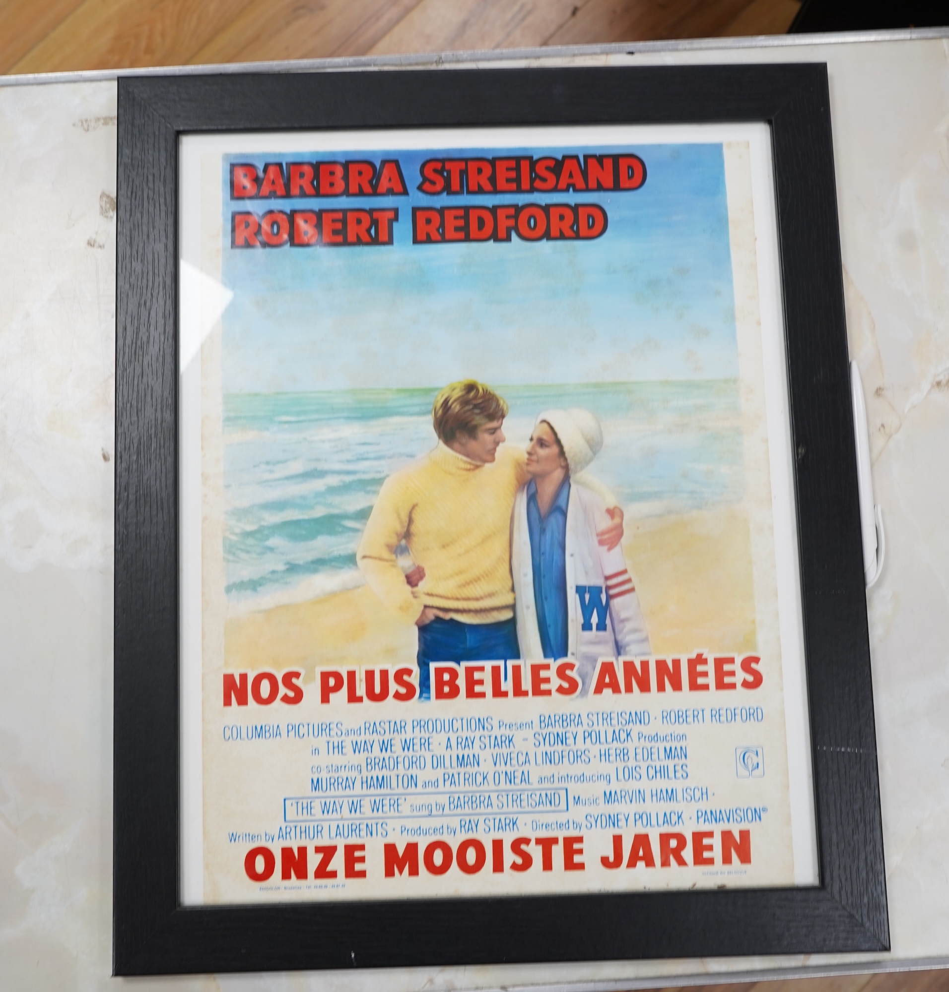 A pair of vintage Belgian film posters, one featuring Barbara Streisand and Robert Redford, printed in Brussels, framed, 48 x 36cm